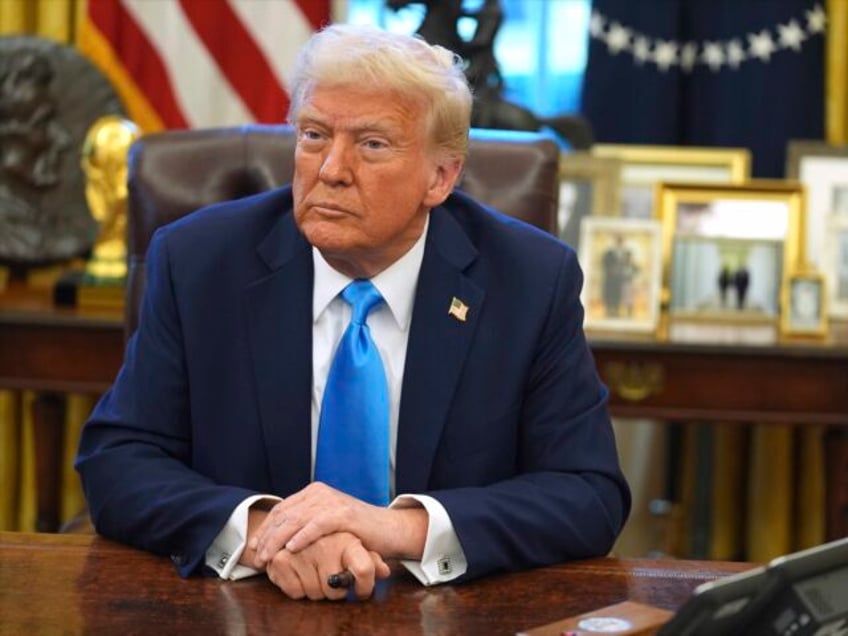 President Donald Trump speaks to reporters as he signs executive orders in the Oval Office