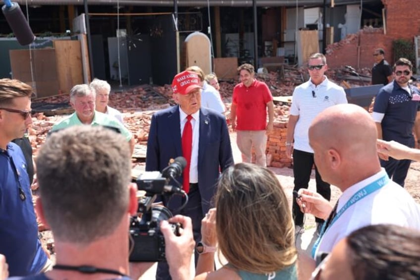 Republican presidential nominee Donald Trump -- pictured inspecting hurricane damage in Va