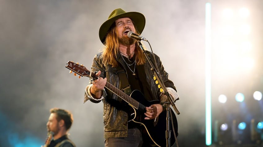 Billy Ray Cyrus performs on stage