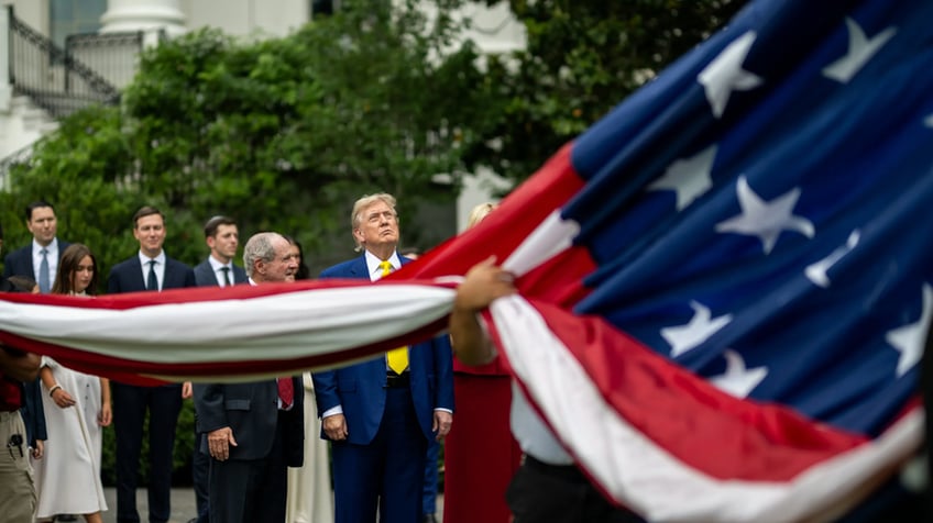Trump watches flag