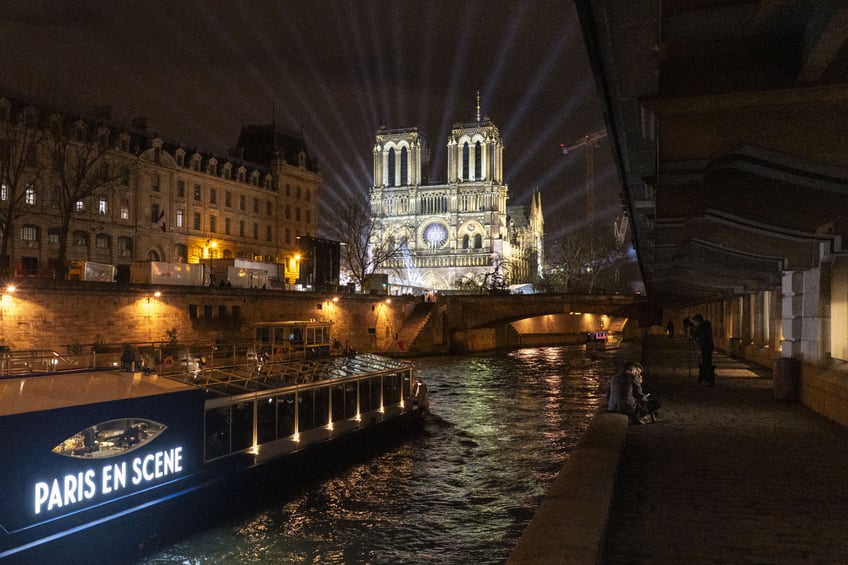 A tourist boat in front of Notre Dame Cathedral ahead of it's formal reopening for the first time since a devastating fire, in Paris, France, on Friday, Dec. 6, 2024. There's still more than a month until inauguration day, but Donald Trump isn't waiting: he makes his first trip abroad since November's election, heading to Paris for the reopening of the Notre Dame Cathedral. Photographer: Nathan Laine/Bloomberg via Getty Images