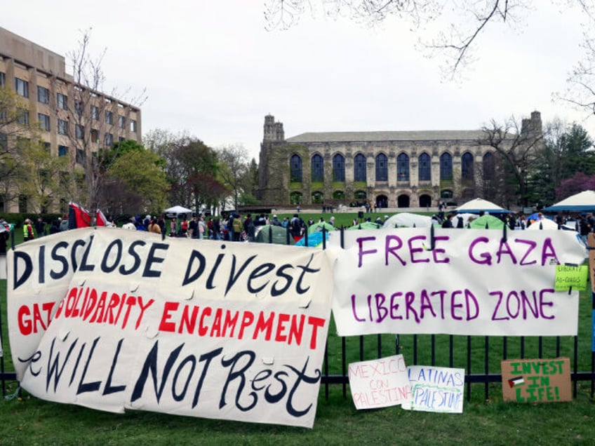 Signs are displayed outside a tent encampment at Northwestern University on Friday, April