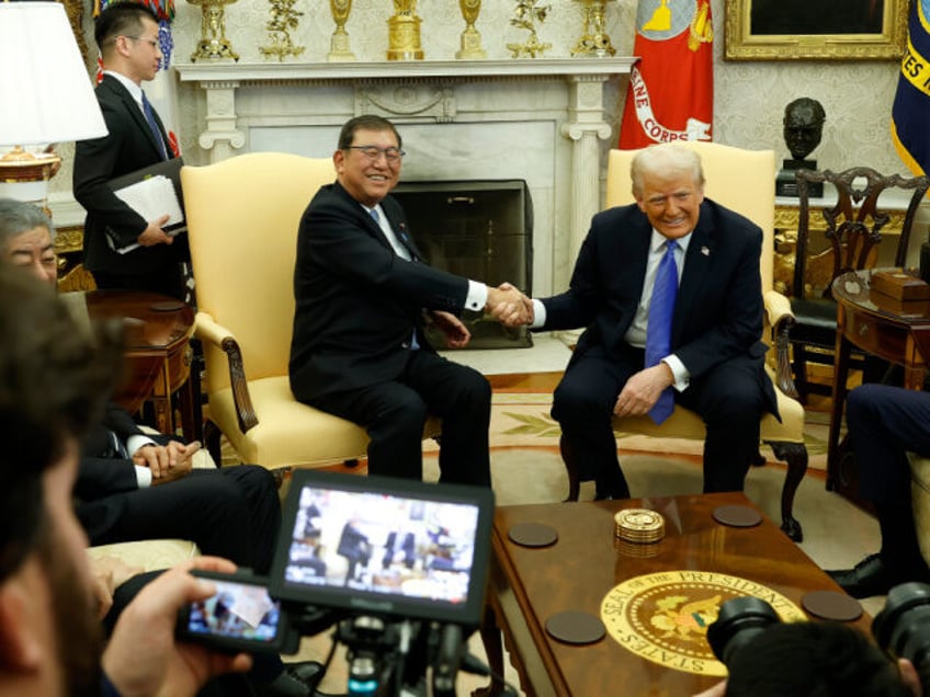 WASHINGTON, DC - FEBRUARY 07: U.S. President Donald Trump shakes hands with Japanese Prime