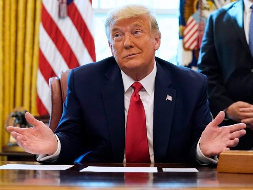 President Donald Trump listens while on a phone call with the leaders of Sudan and Israel,