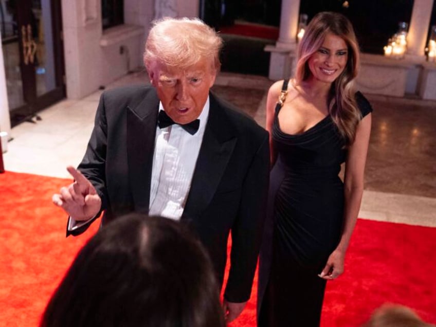 Melania Trump looks on as President-elect Donald Trump speaks to reporters before a New Ye