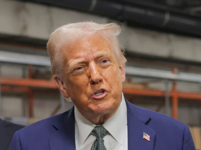 President Donald Trump talks to reporters as Richard Grenell, president of the Kennedy Cen