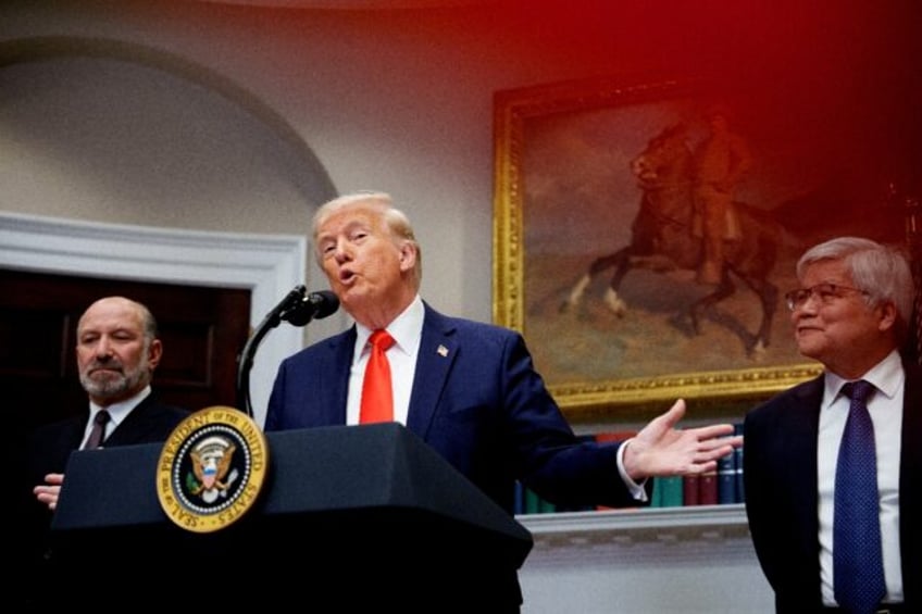 US President Donald Trump, accompanied by Commerce Secretary Howard Lutnick (L) and Taiwan