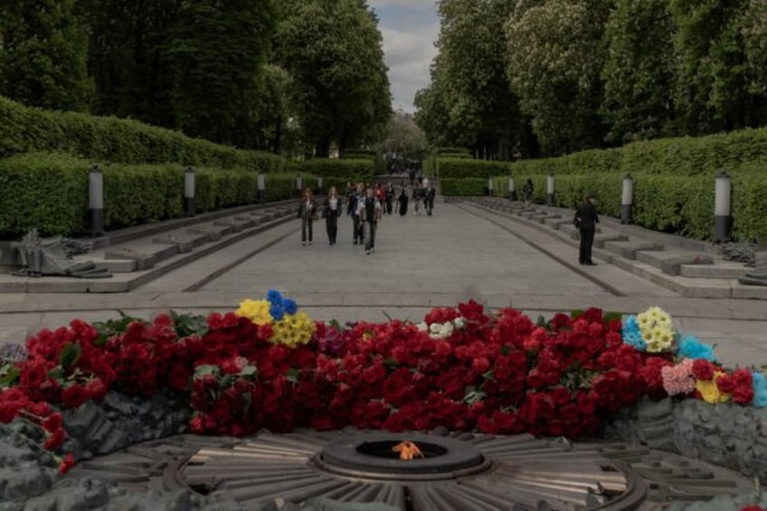 People walk past the Tomb of the Unknown Soldier at the World War II memorial on the Day o