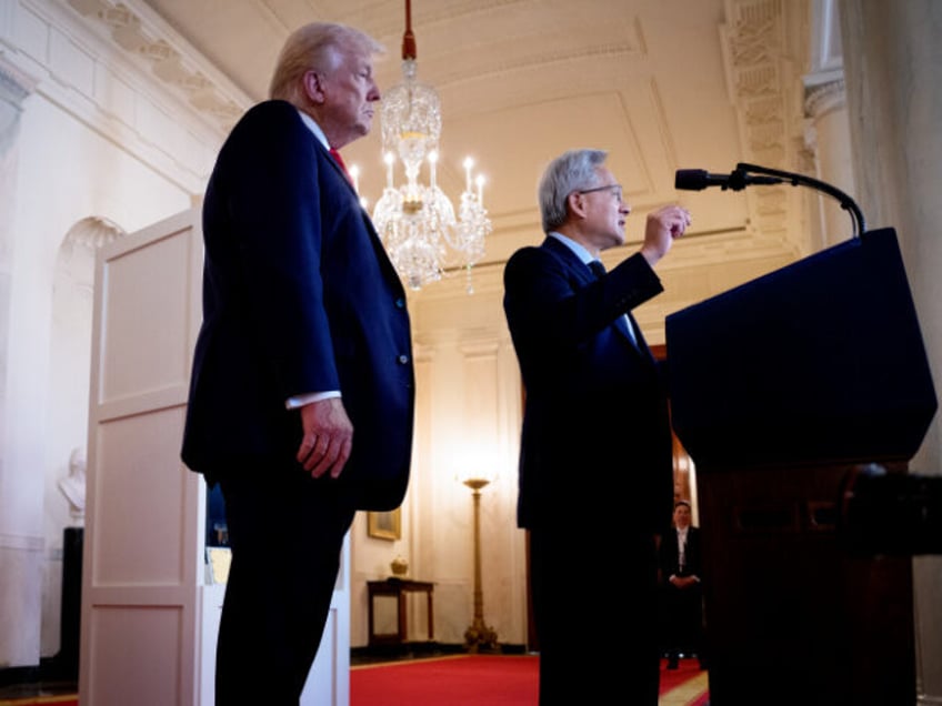U.S. President Donald Trump (L) listens as Nvidia CEO Jensen Huang speaks in the Cross Hal