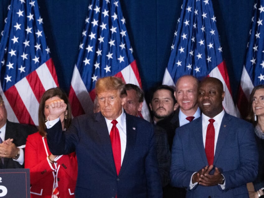 Former US President Donald Trump, center, and Senator Tim Scott, a Republican from South C