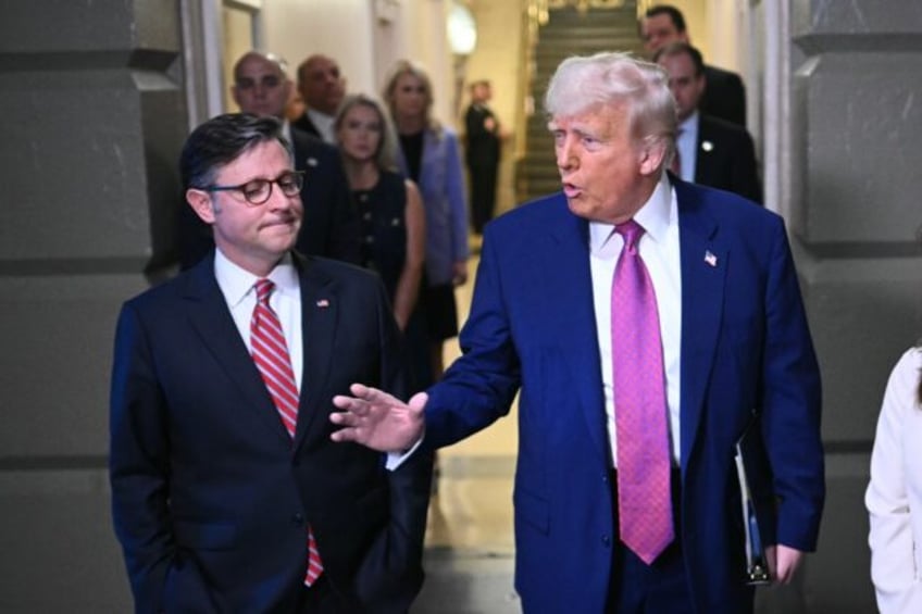 US President Donald Trump (R) was accompanied by US Speaker of the House Mike Johnson duri
