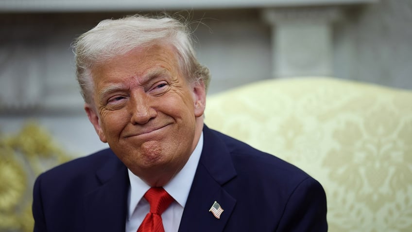 President Donald Trump grins
