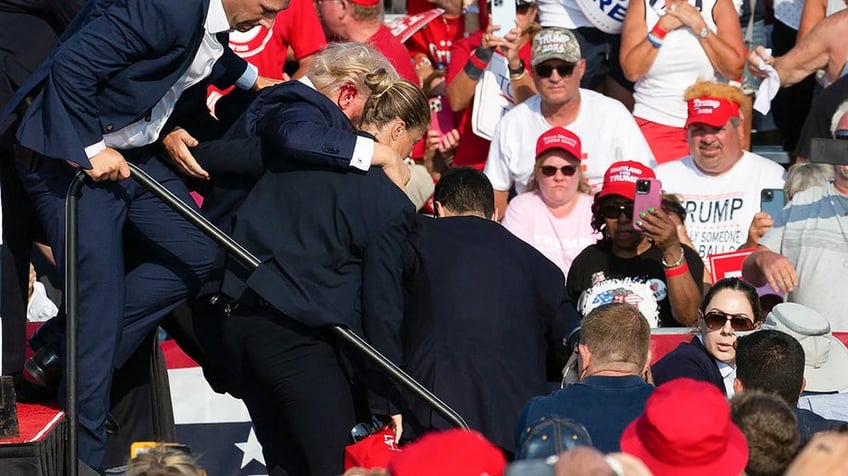 Donald Trump is seen with blood on his face