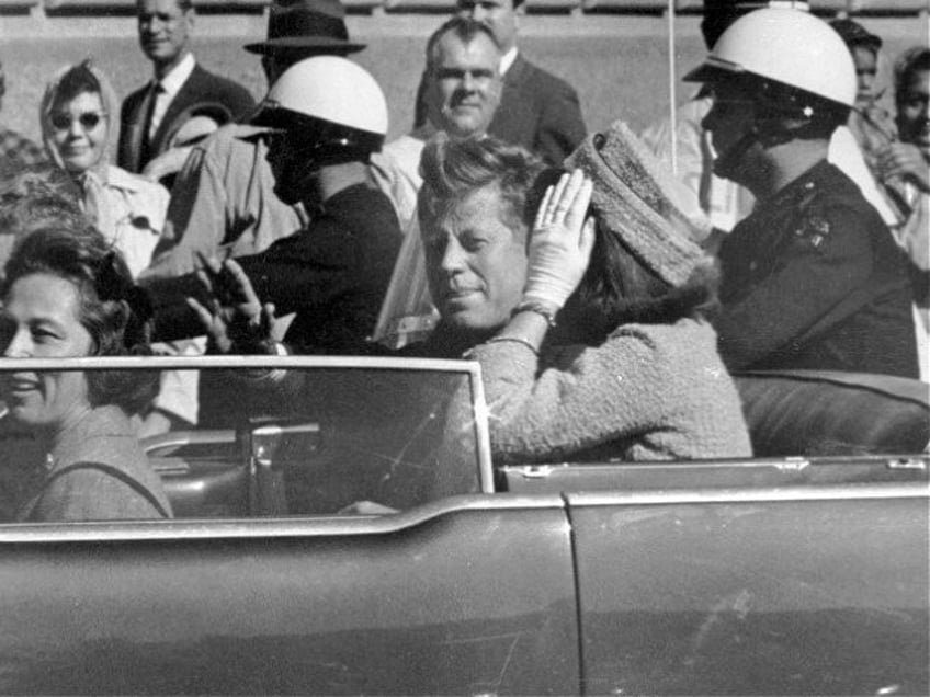 FILE - In this Nov. 22, 1963 file photo, President John F. Kennedy waves from his car in a