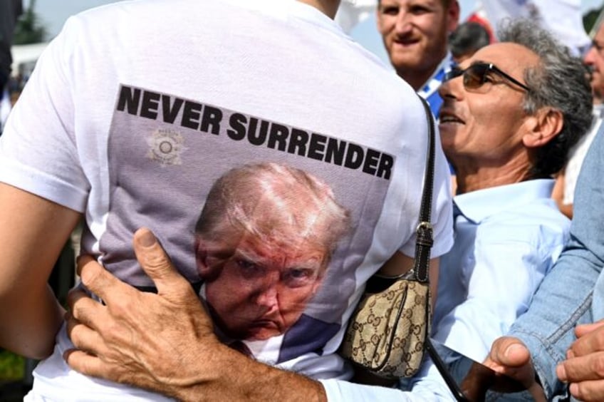 A woman wears a tee-shirt depicting the mug shot of President-elect Donald Trump in Pontid