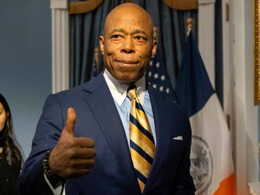 New York City Mayor Eric Adams gestures as he leaves a press conference at City Hall follo