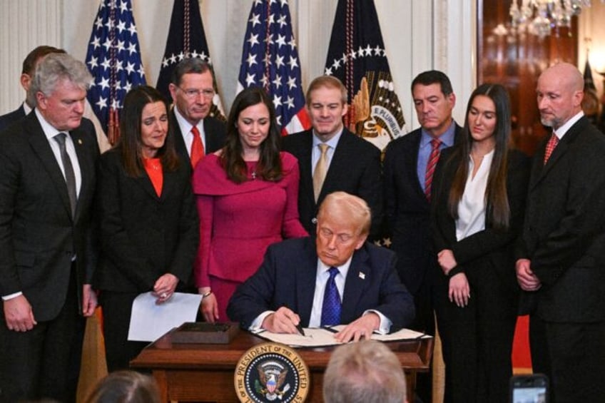 US President Donald Trump signs the Laken Riley Act in the East Room of the White House