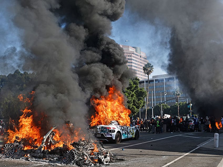 Waymo cars burn during immigration raid protests on June 08, 2025 in Los Angeles, Californ