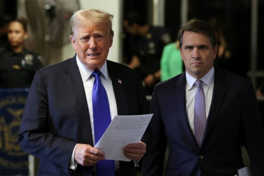 President Donald Trump, flanked by his lawyer Todd Blanche, speaks to reporters at his hus