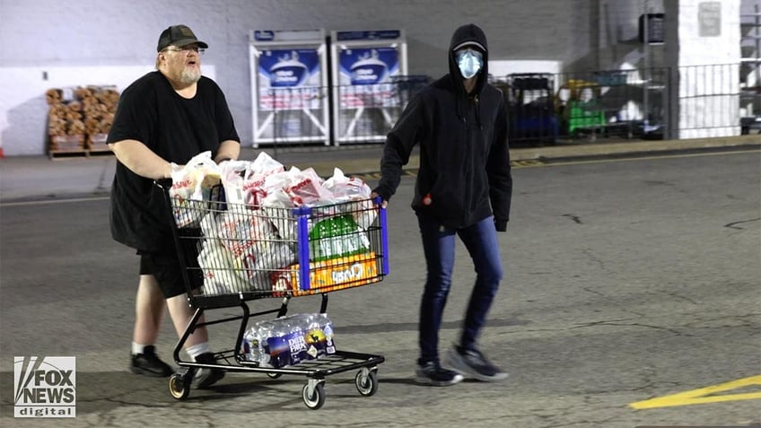 Trump assassin's father Thomas Crooks with a full shopping cart in the carpark of a supermarket.