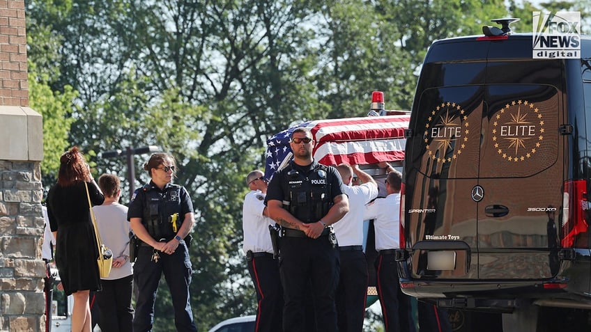 The casket of Corey Comperatore is carried into Cabot United Methodist Church