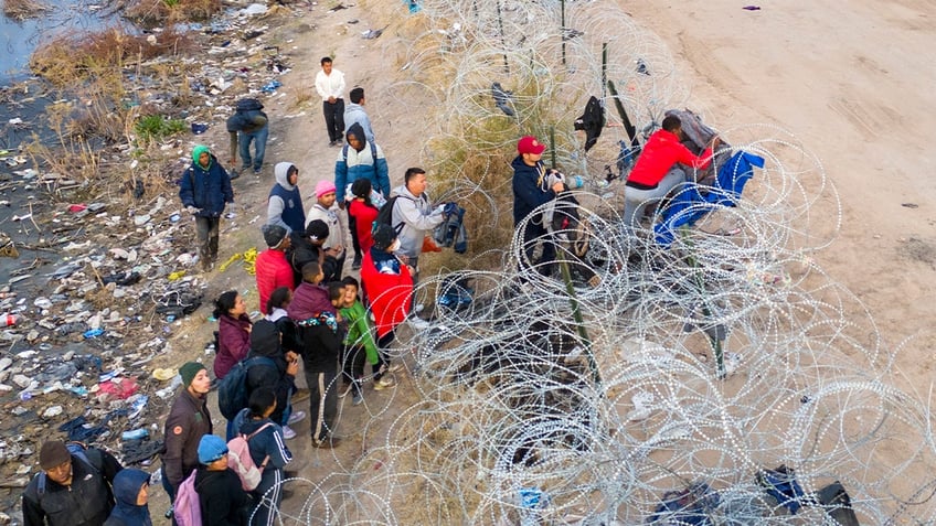 Illegal aliens crossing wire at southern border