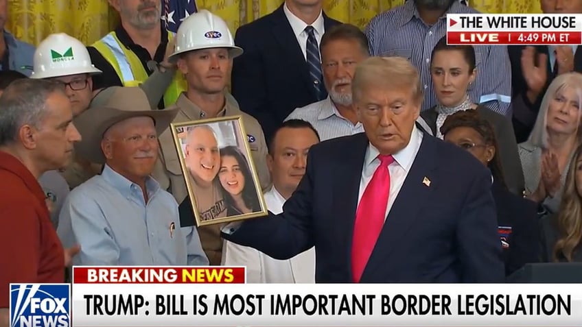 Trump with photo of slain woman
