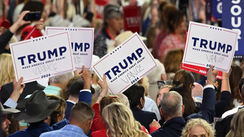 A person holds a sign endorsing Republican presidential candidate, Donald Trump