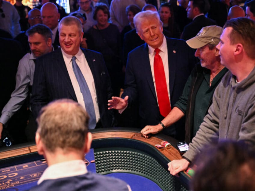 US President Donald Trump visits with patrons at a craps table at Circa Resort & Casin