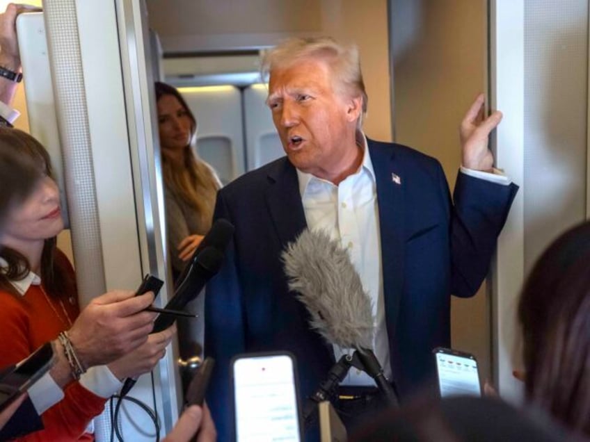 President Donald Trump speaks to reporters aboard Air Force One as he travels from Las Veg