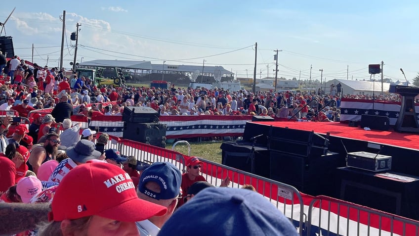 Trump attend a rally and wait for the former president's address.