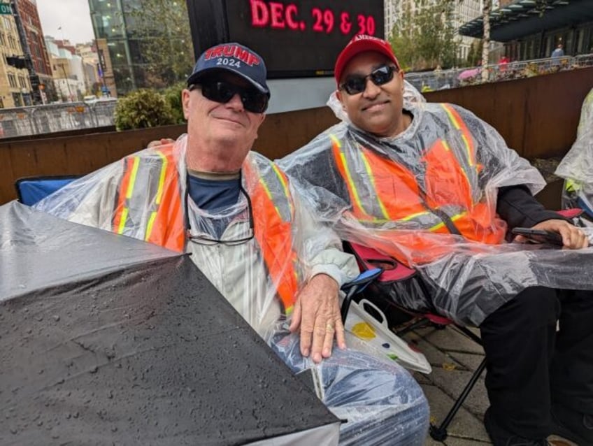 Jeff Dickerson (L) and Nigel Mahabir (R) wait in line to enter a campaign rally for Republ