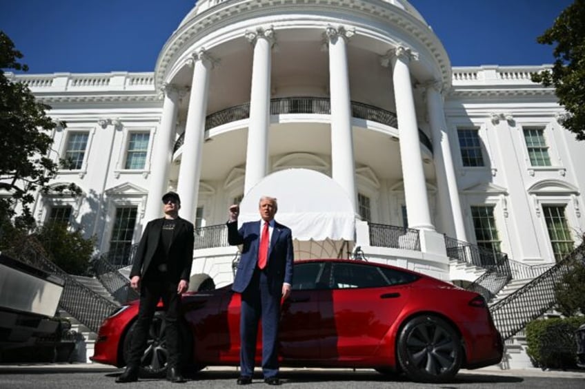 US President Donald Trump and Tesla CEO Elon Musk speak to the press as they stand next to