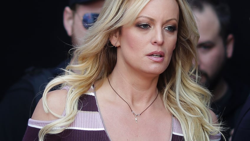 FILE - In this Oct. 11, 2018, file photo, adult film actress Stormy Daniels arrives for the opening of the adult entertainment fair "Venus," in Berlin.  (AP Photo/Markus Schreiber, File)