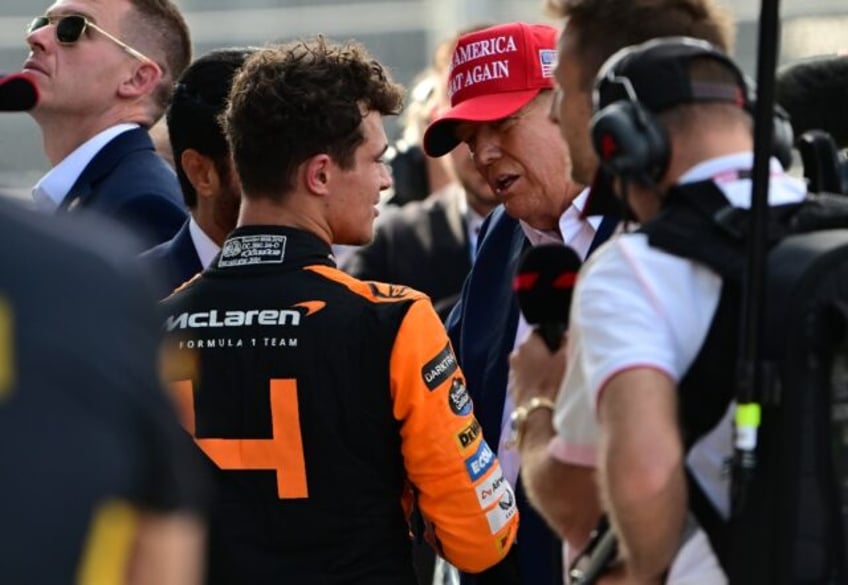 McLaren's British driver Lando Norris is congratulated by former US President and 2024 pre