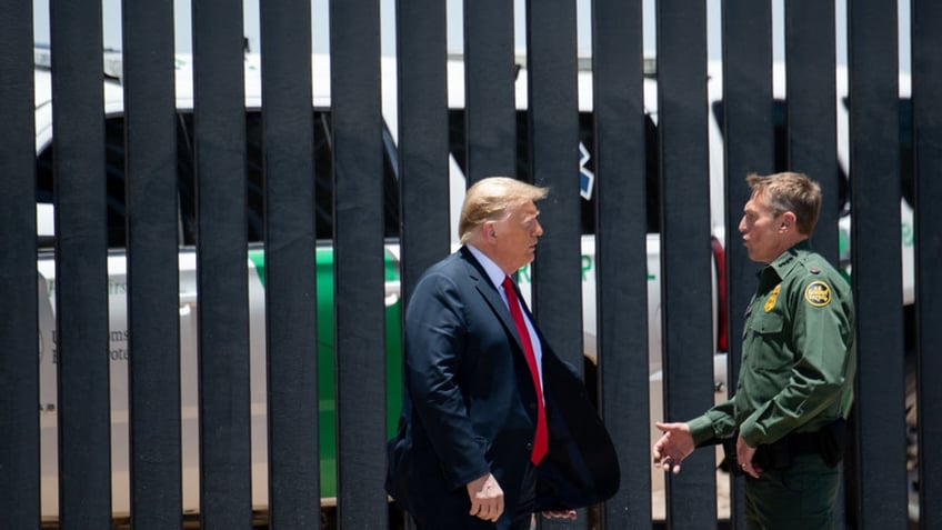 Trump walks along border wall