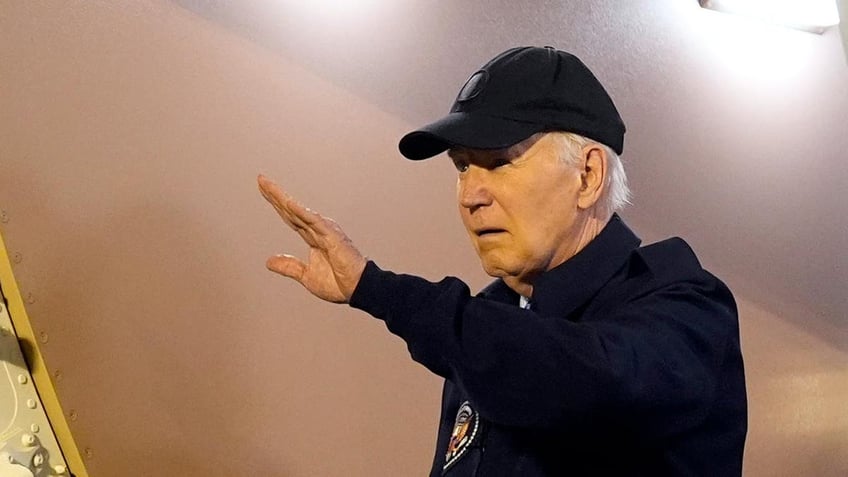 Joe Biden hand raised in closeup shot leaving Air Force One