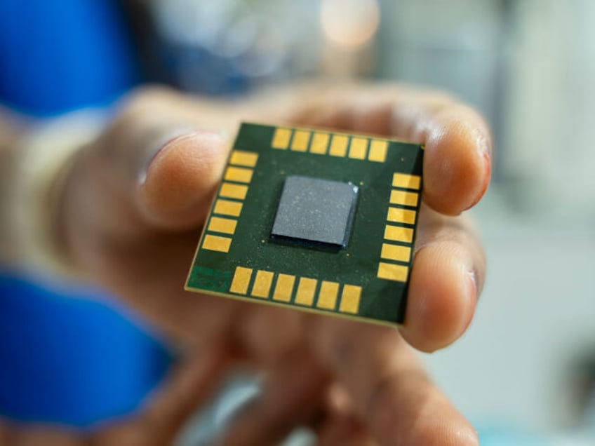 A person displays a computer chip in a stall during The Advantage Assam 2.0 Investment Sum