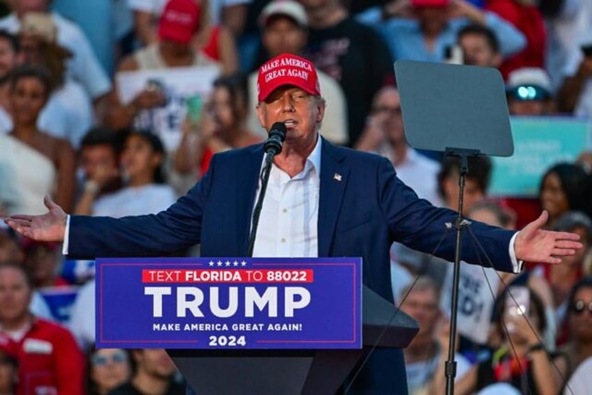 Former US President and Republican presidential candidate Donald Trump gestures as he spea