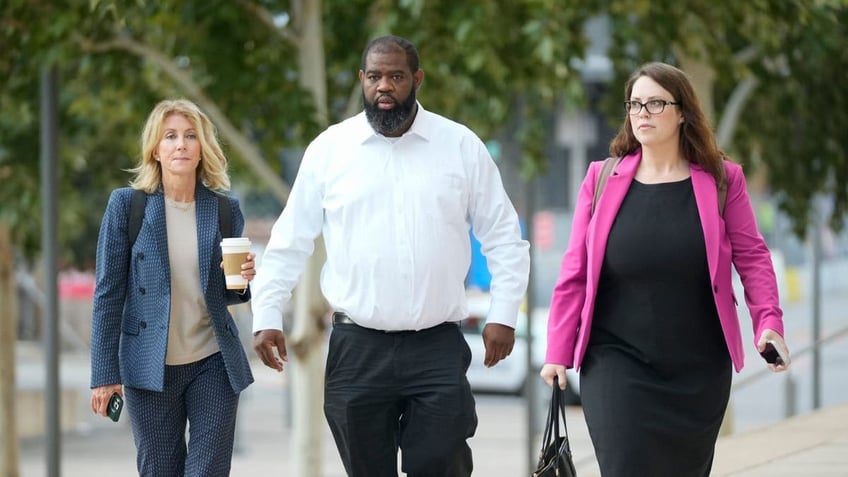 Former state senator Wendy Davis, left, and bus driver Tim Holloway, along with their attorney, right. 