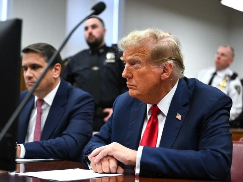 Former President Donald Trump, center, at Manhattan criminal court in New York on Monday,