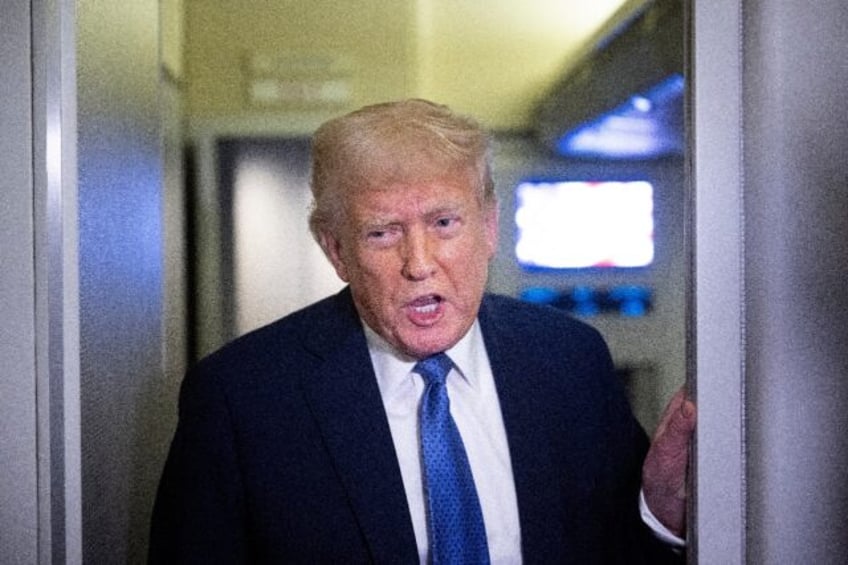 US President Donald Trump speaks to reporters aboard Air Force One while flying to Washing