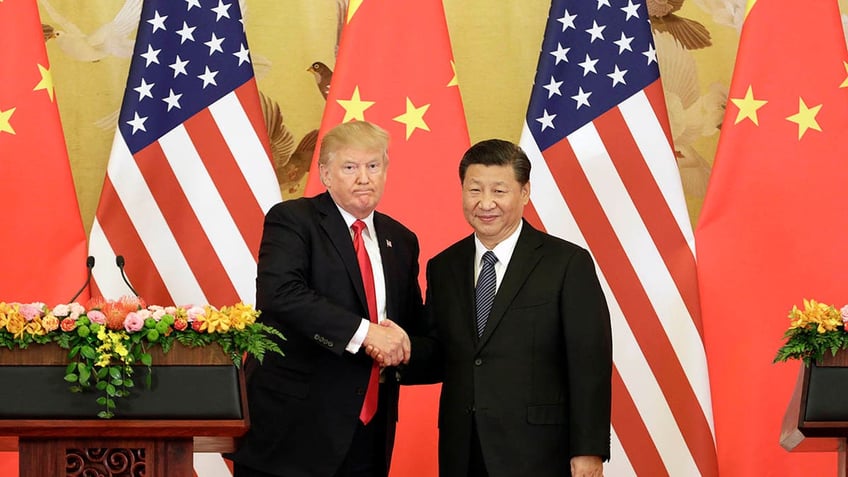 Trump shaking hands with Xi