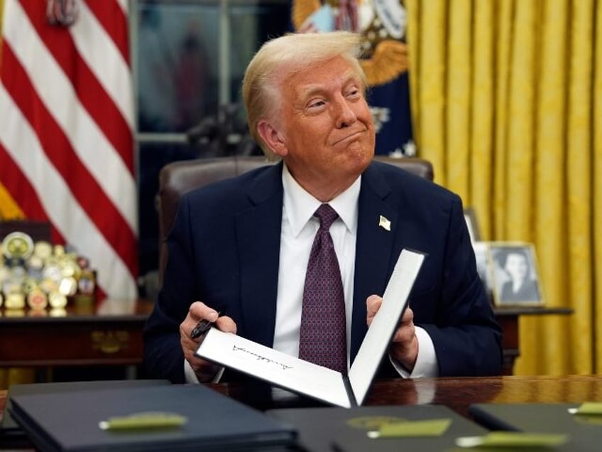 President Donald Trump signs executive orders in the Oval Office of the White House, Monda