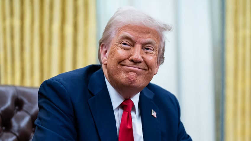 Trump grinning in office