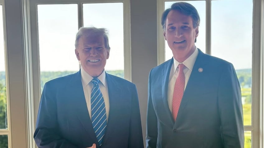 former President Trump and Gov. Glenn Youngkin smile for photo