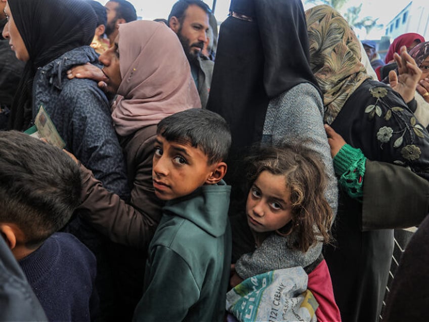 KHAN YUNIS, GAZA - JAN 21: Palestinians in need queued up to receive their aid parcels, di