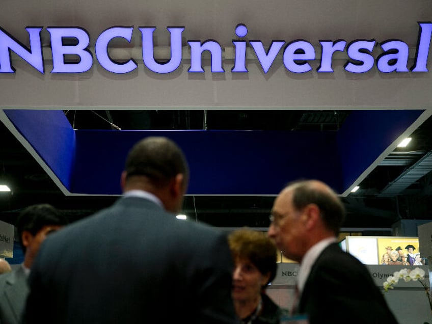 The logo of Comcast Corp.'s NBCUniversal Media LLC is seen on the exhibit floor durin