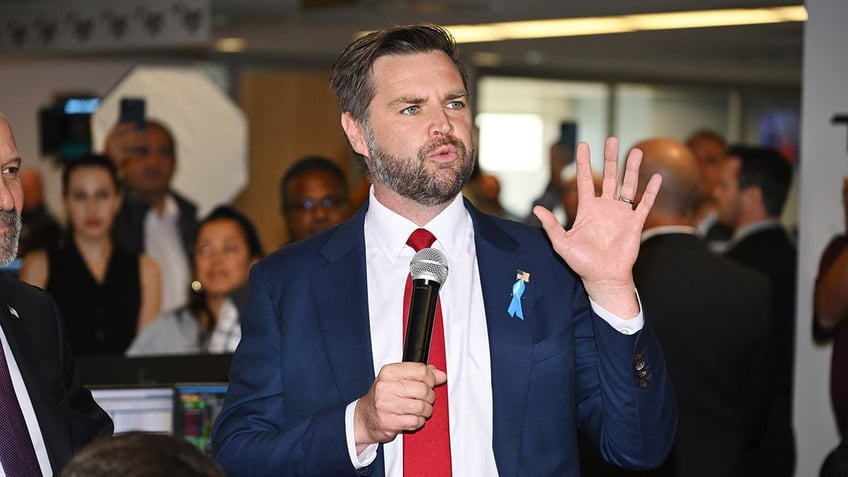 JD Vance closeup shot, holding microphone