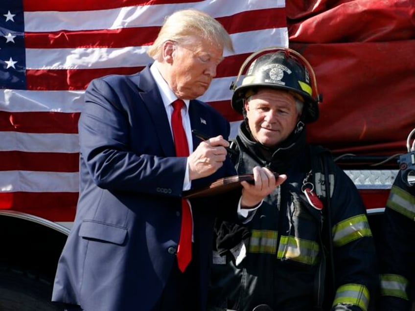 President Donald Trump talks with firefighters after touring Puritan Medical Products, a m